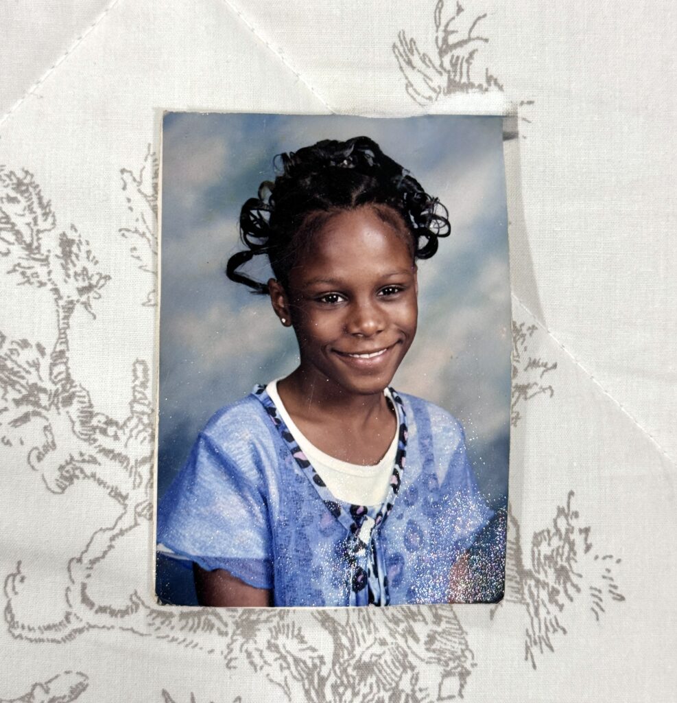 Childhood school portrait of Tam from Tambella Photography, age 10, sitting for a traditional school photo.